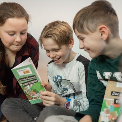 Kinder lesen in einem Adventures in the book-Buch